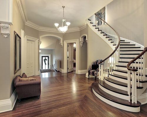 Foyer in traditional suburban home with curved staircase